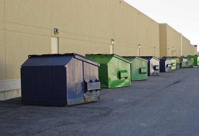 a group of construction workers taking a break near a dumpster in Barrington